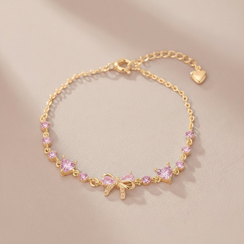 Gold bracelet with pink gemstones on a beige background