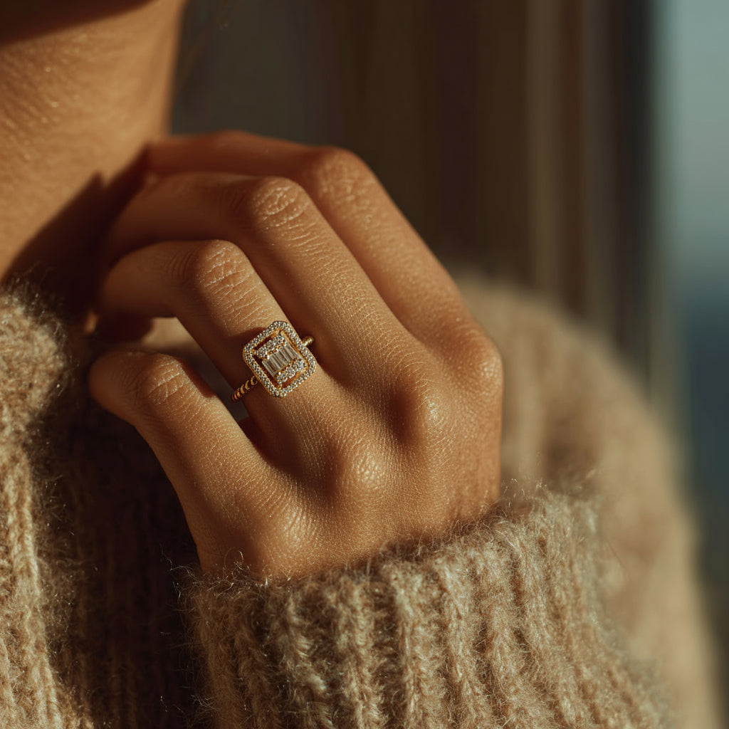 Close-up of a hand wearing a diamond ring with a blurred background