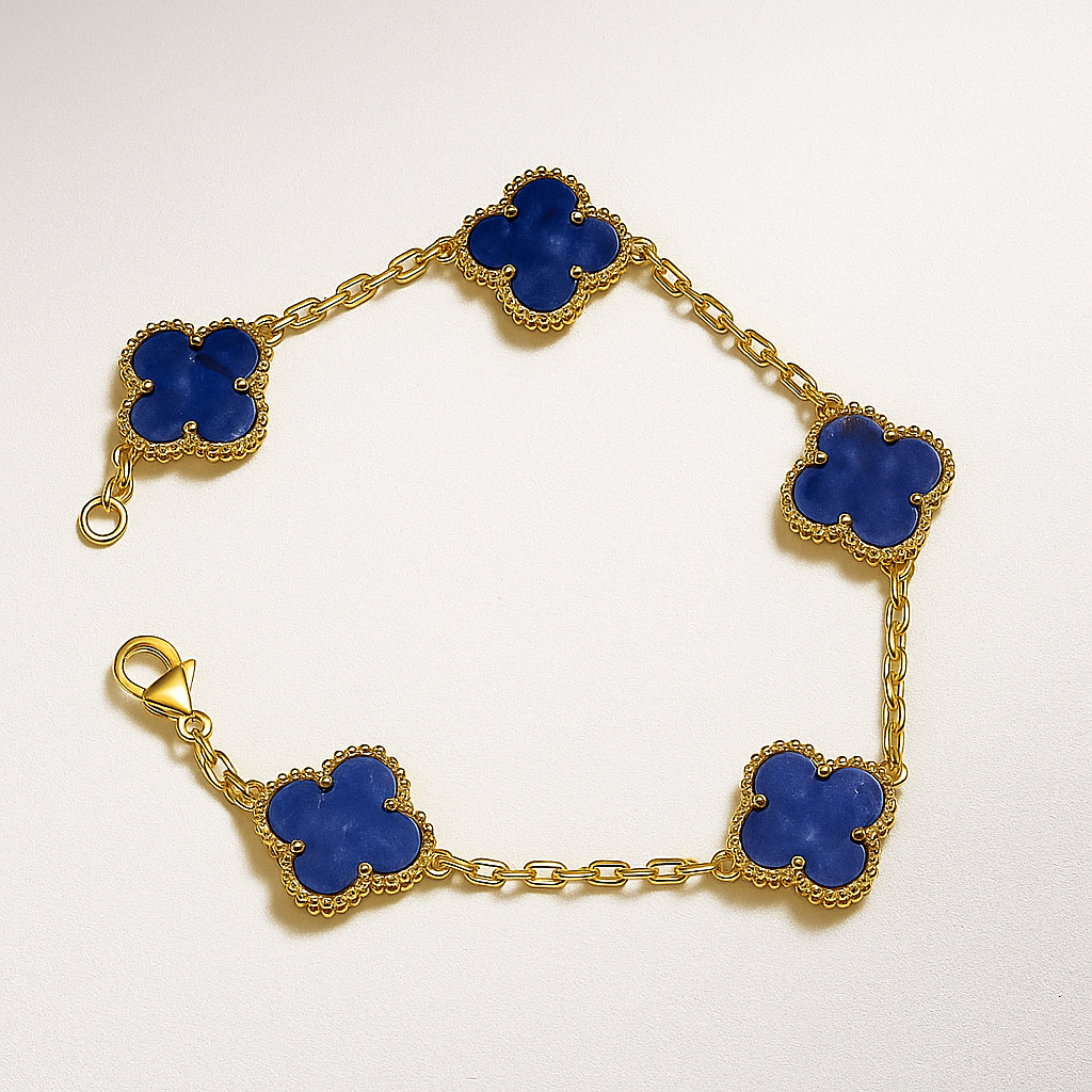 Gold bracelet with blue clover-shaped charms on a white background