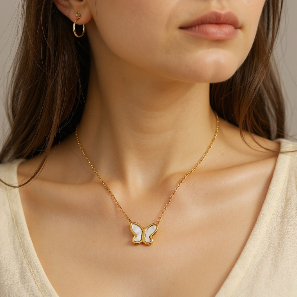 Close-up of a woman wearing a gold necklace with a butterfly pendant.
