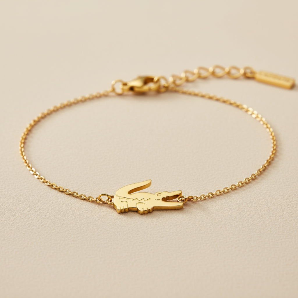 Gold bracelet with a Croc design on a beige background