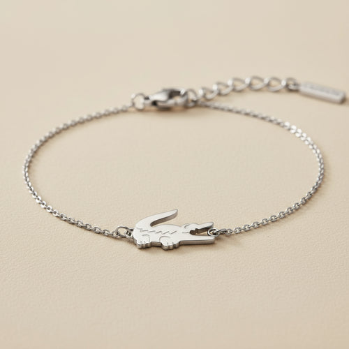 Silver bracelet with a Croc design on a beige background