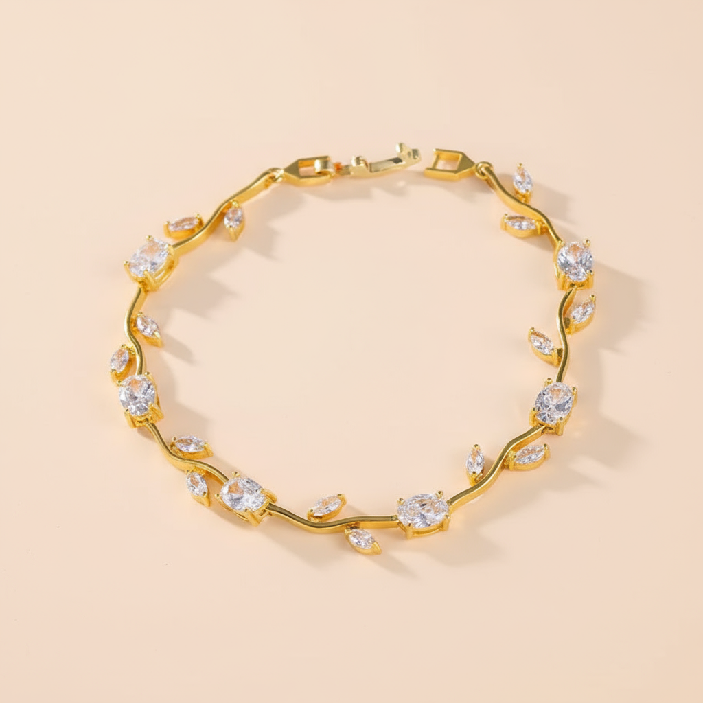 Gold bracelet with crystal stones on a beige background