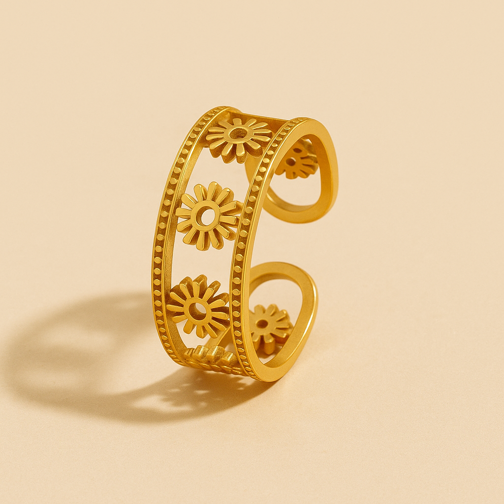 Gold ring with floral designs on a beige background