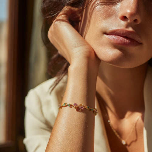 Close-up of a woman's arm wearing a colorful bracelet with a blurred background