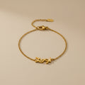 Gold bracelet with a clasp on a beige background