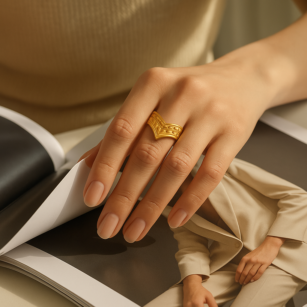 Hand wearing a Geometric Edge Ring on a magazine