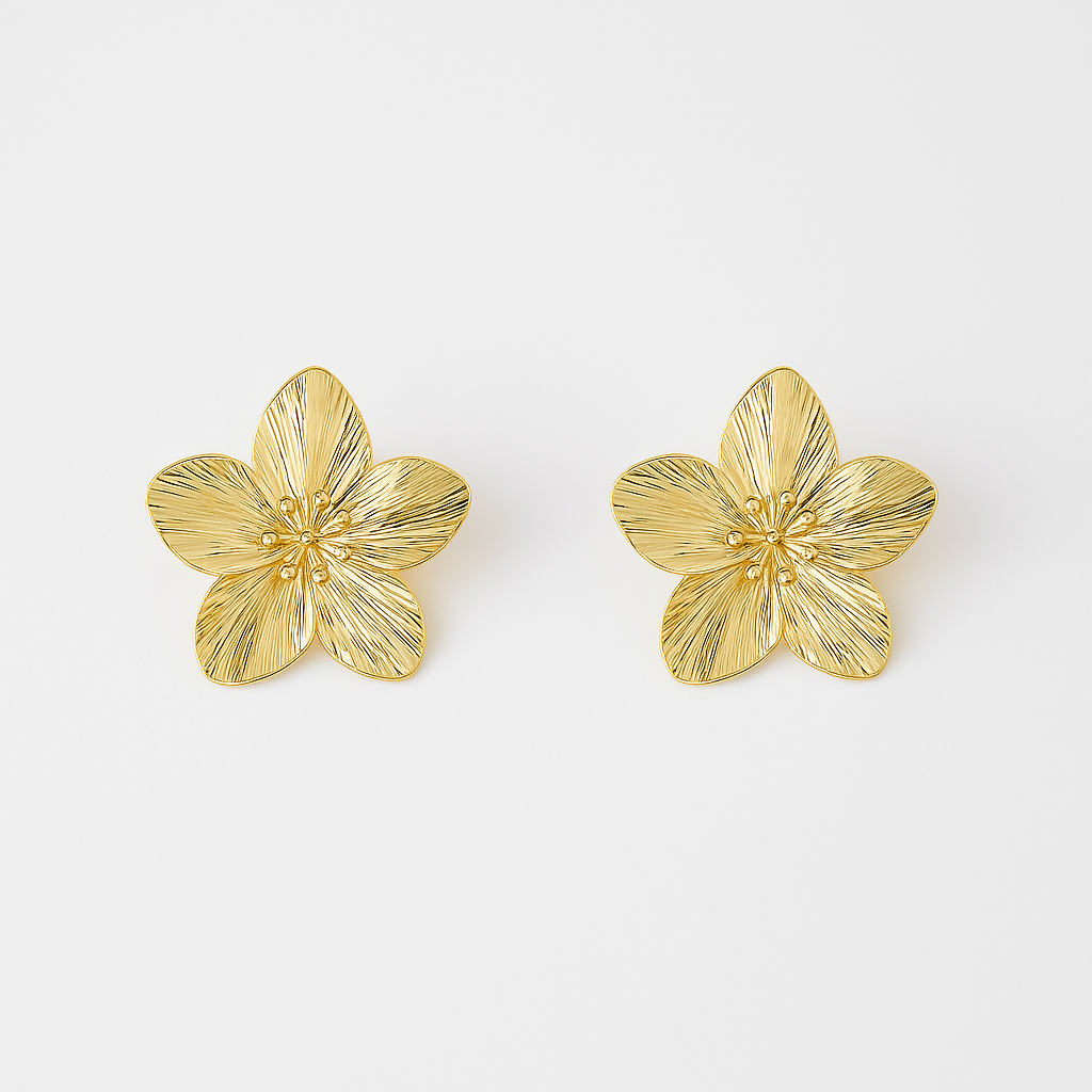 Pair of gold flower-shaped earrings on a white background