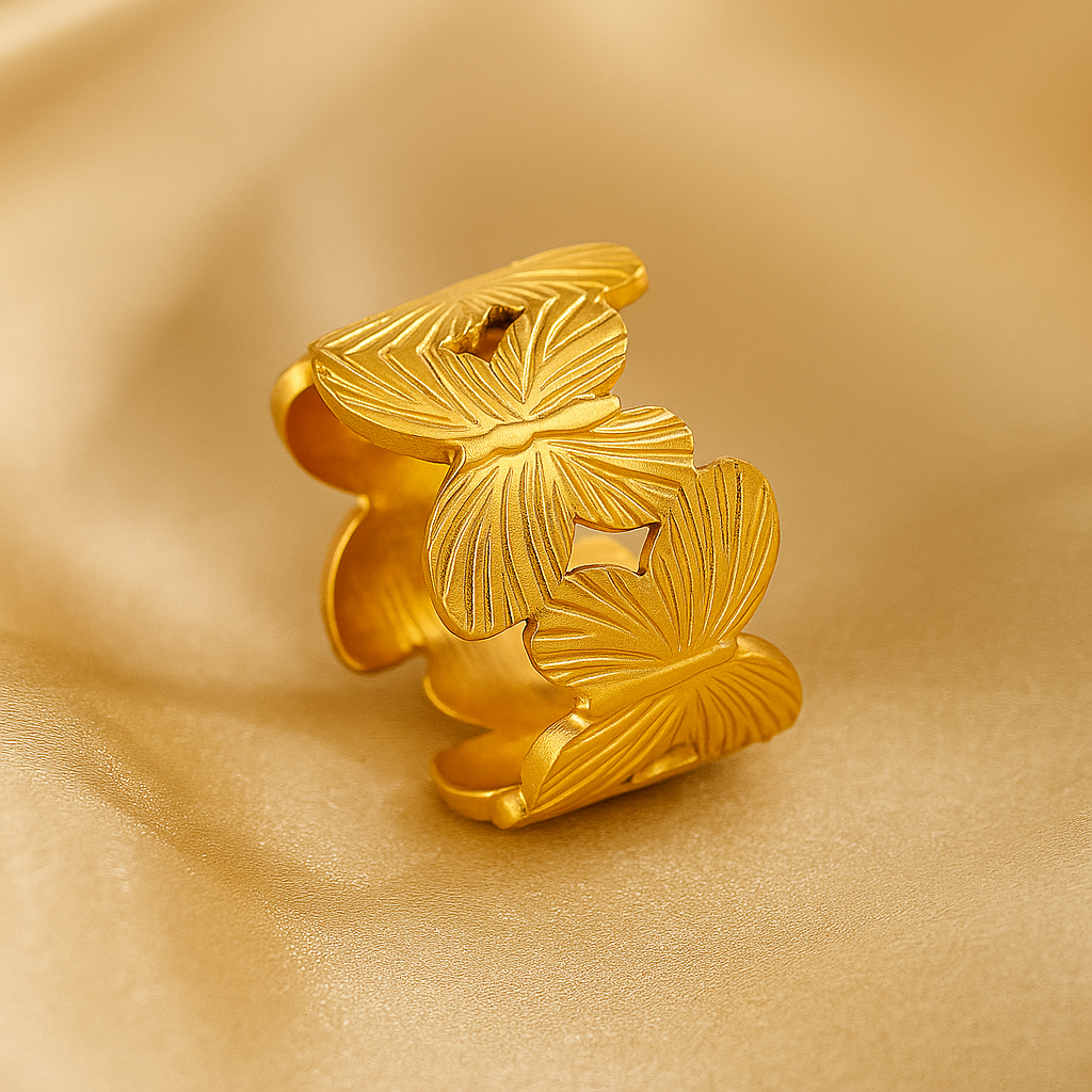 Gold butterfly-shaped ring on a gold background