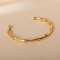 Gold bracelet on a beige background
