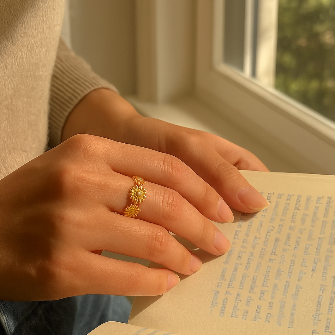 Person holding an open book with a gold ring on a blurred indoor background