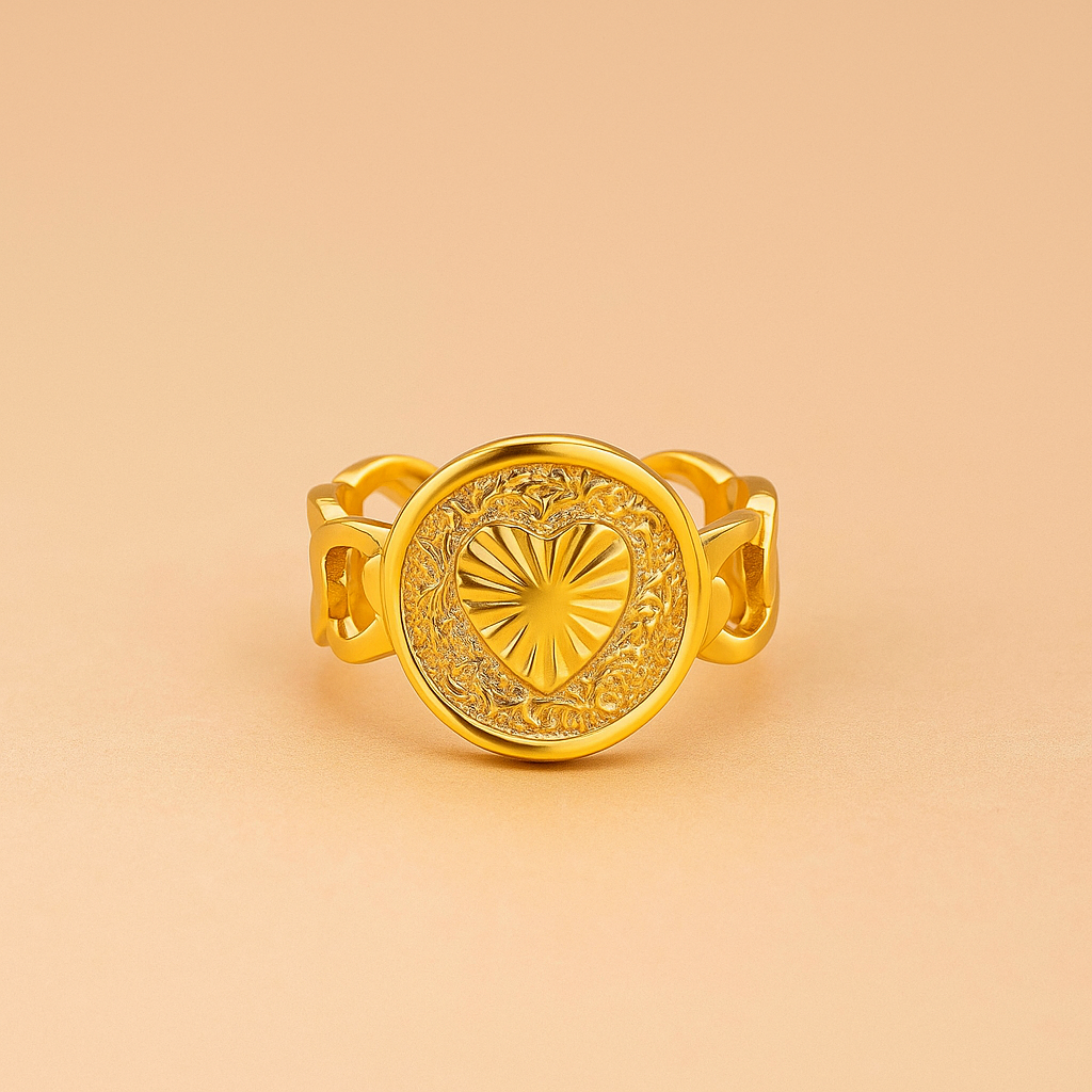 Golden Heart Medallion Ring with intricate design on a beige background