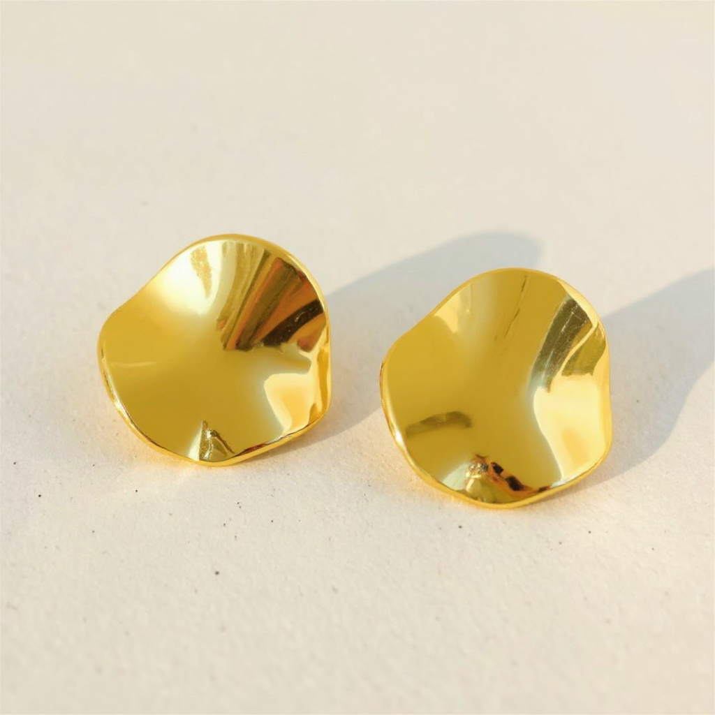 Pair of Golden Petal Earrings on a light beige background