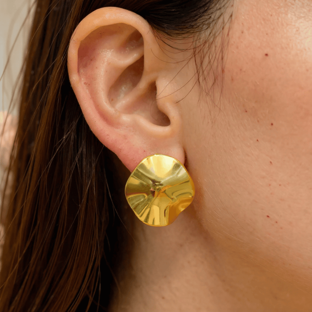 Golden Petal Earrings worn by a person with brown hair.