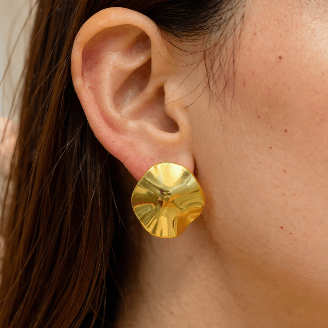 Golden Petal Earrings worn by a person with brown hair.