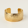 Hammered Glow Bangle on a light beige background