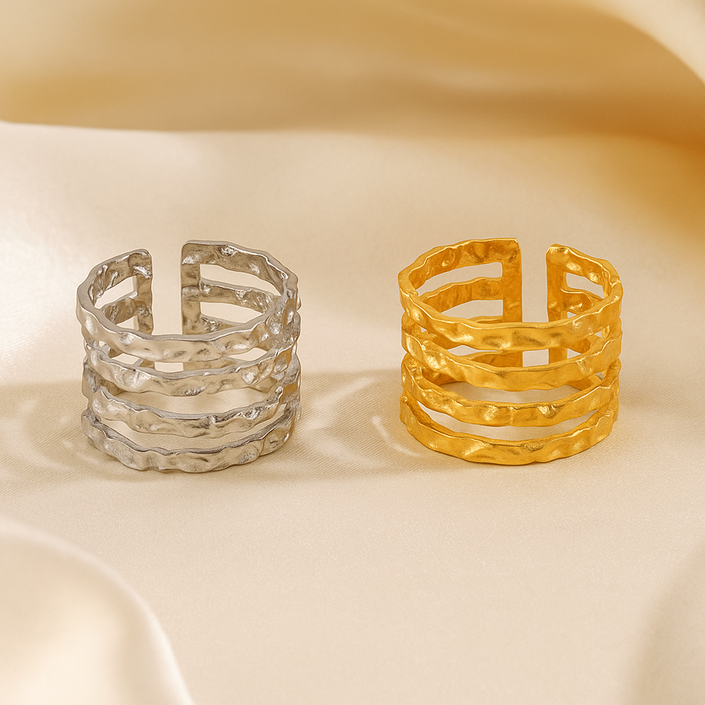 Two gold and silver rings on a beige background