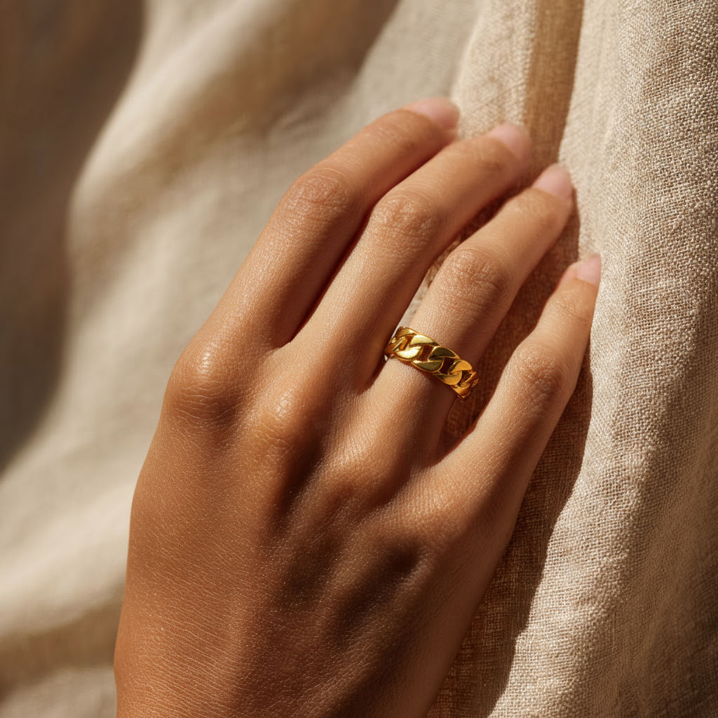 Hand wearing a Chain-Link Gold Ring with a cup of coffee on a marble surface