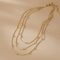 Gold necklace on a beige background