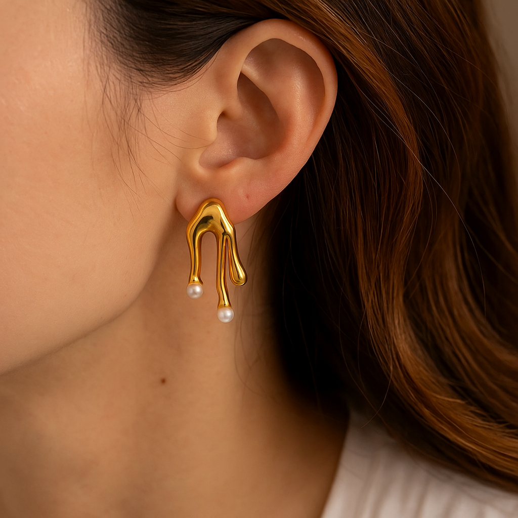 Gold earring with pearls worn by a person