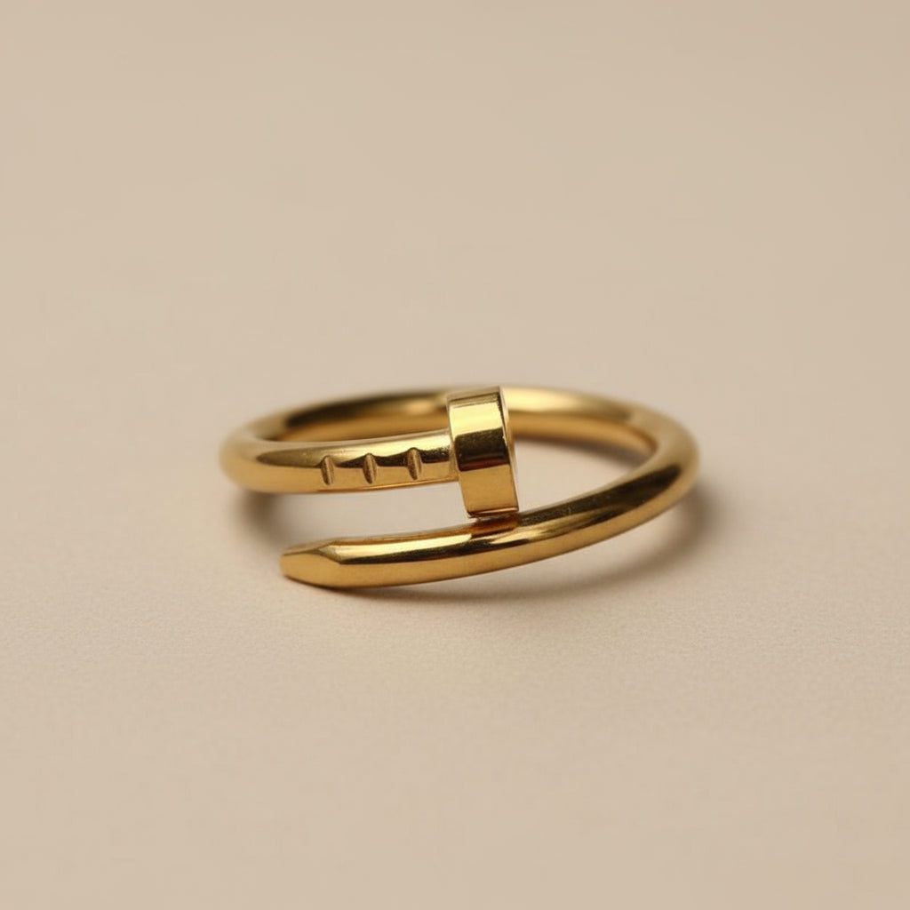 Gold ring with a plain design on a beige background