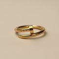 Gold ring with a plain design on a beige background