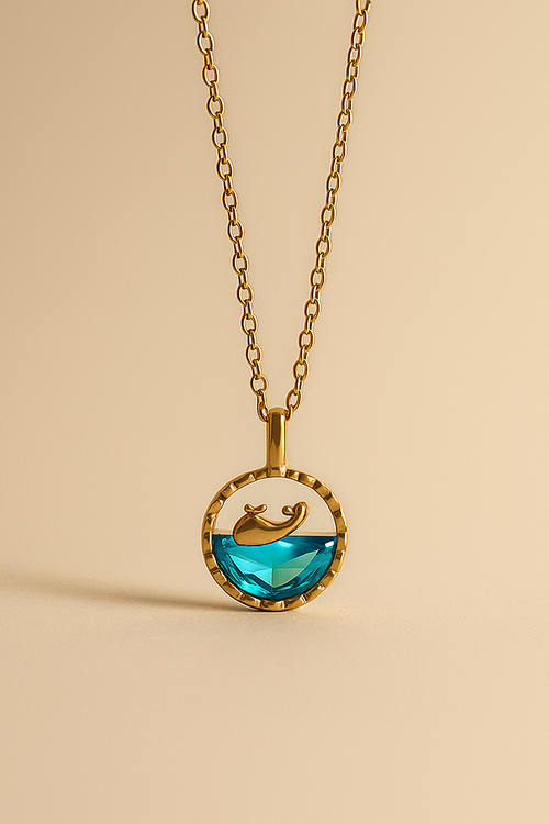 Gold necklace with a Ocean pendant on a beige background