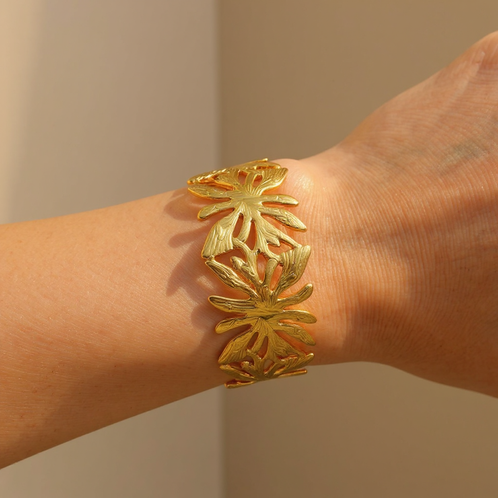 Gold Palm Breeze Bangle on a wrist against a neutral background