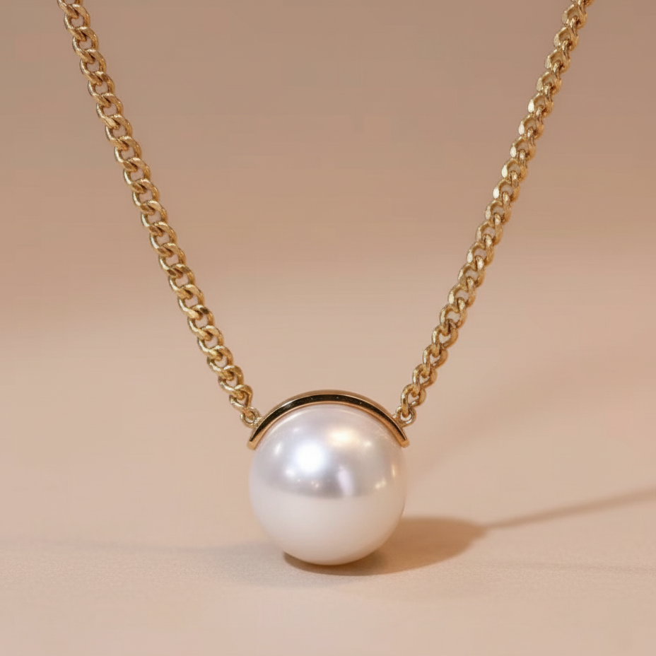 Pearl necklace with gold chain on a beige background