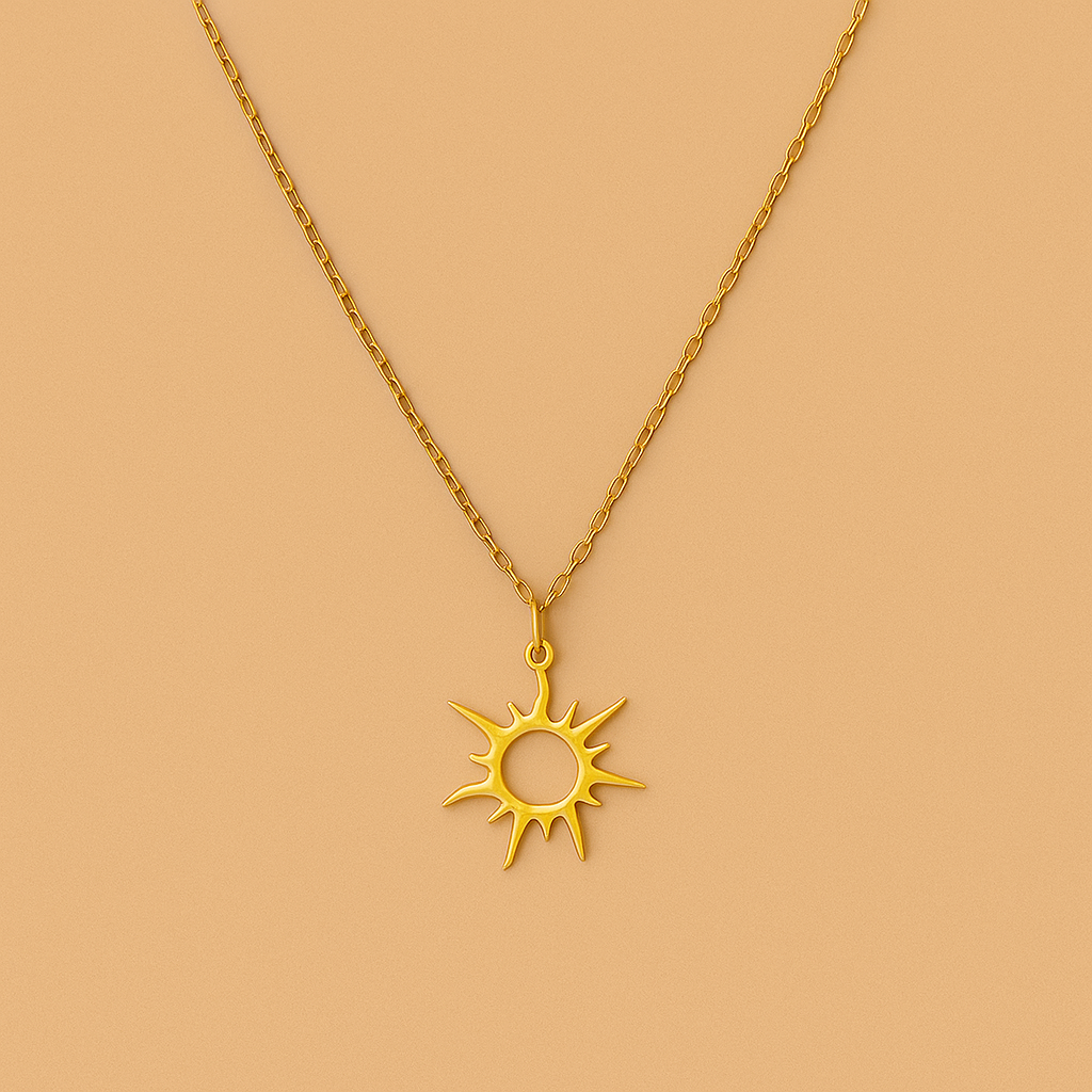 Gold sun-shaped pendant necklace on a beige background