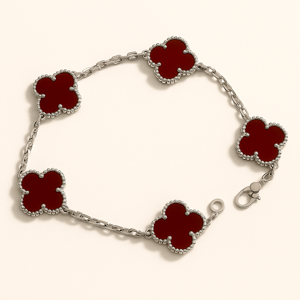 Silver Bracelet with red clover-shaped links on a white background