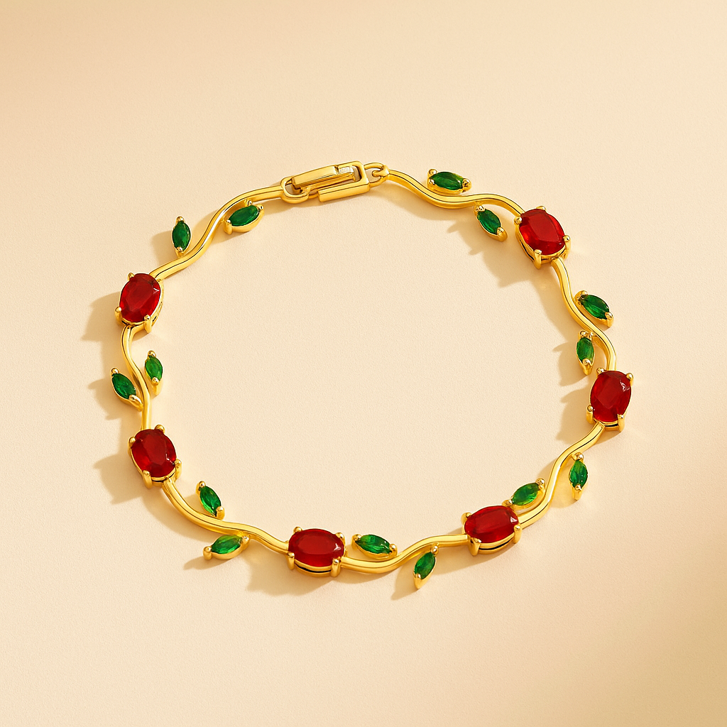 Gold bracelet with red and green gemstones on a beige background