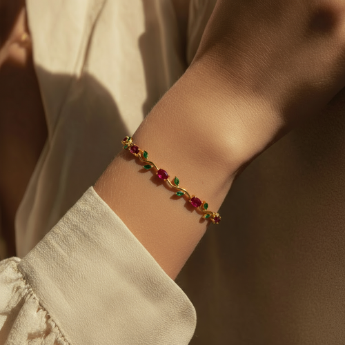 Person wearing a bracelet with red and green beads.
