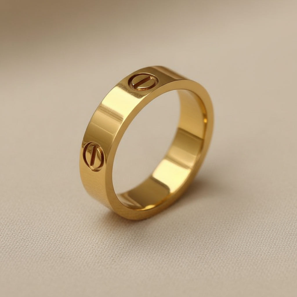 Gold ring with engraved symbols on a beige background