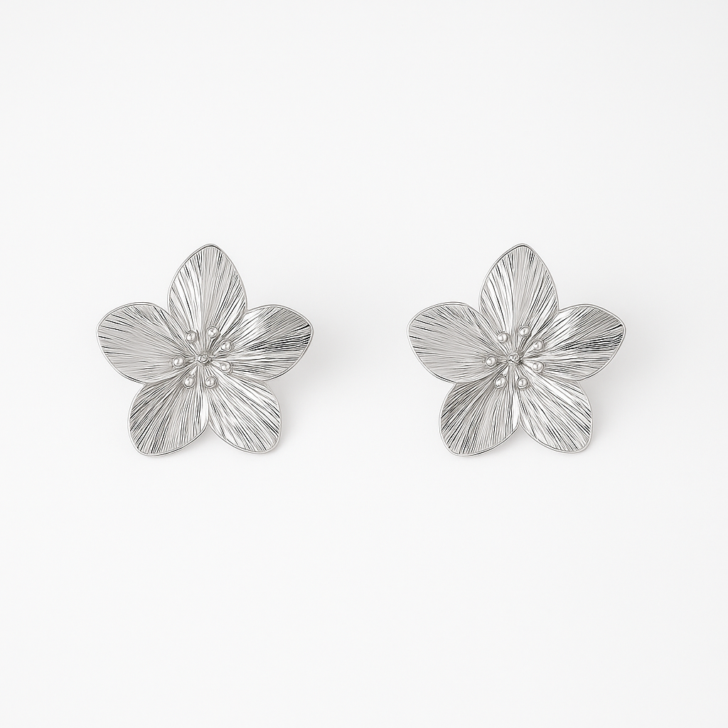 Pair of silver blossom earrings on a white background