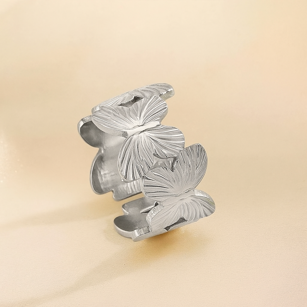 Butterfly Bloom Ring on a beige background.
