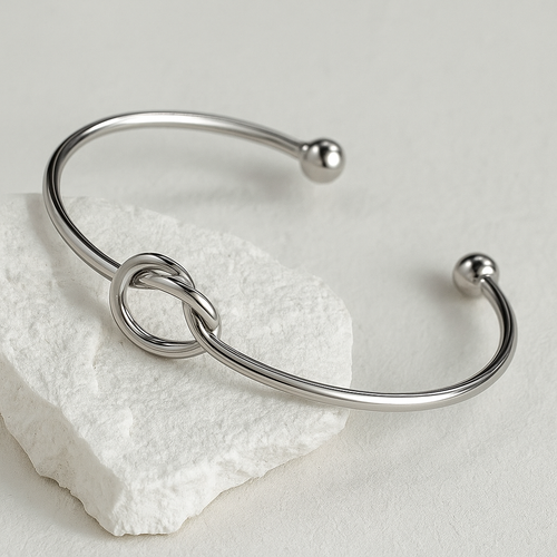 Silver knot bracelet on a light gray background