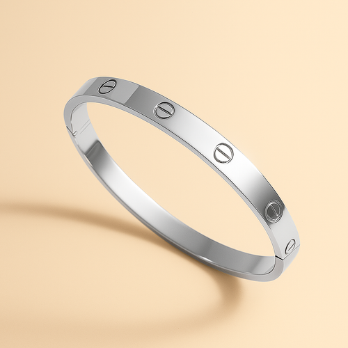 Silver bracelet with engraved design on a beige background