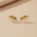Sol earrings on a beige background