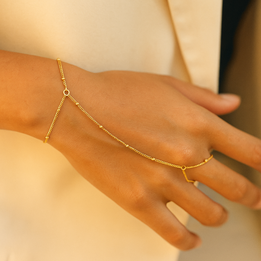 Gold Solara Handchain on a hand against a neutral background