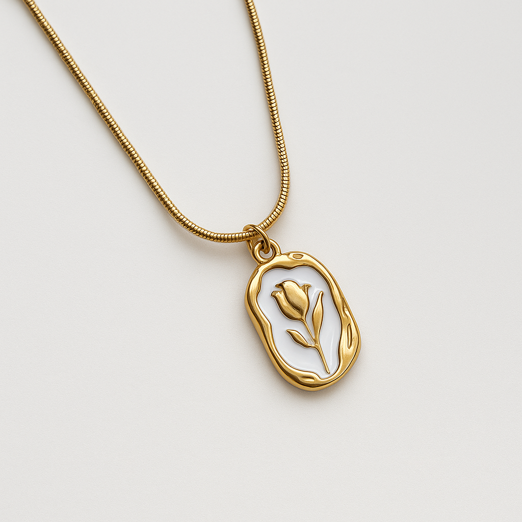 Gold necklace with a pendant featuring a tulip design on a light gray background