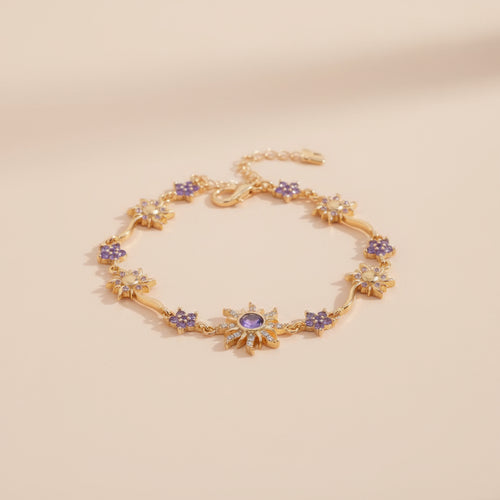 Gold bracelet with purple stones on a beige background