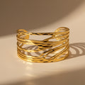 Gold Bangle on a beige background