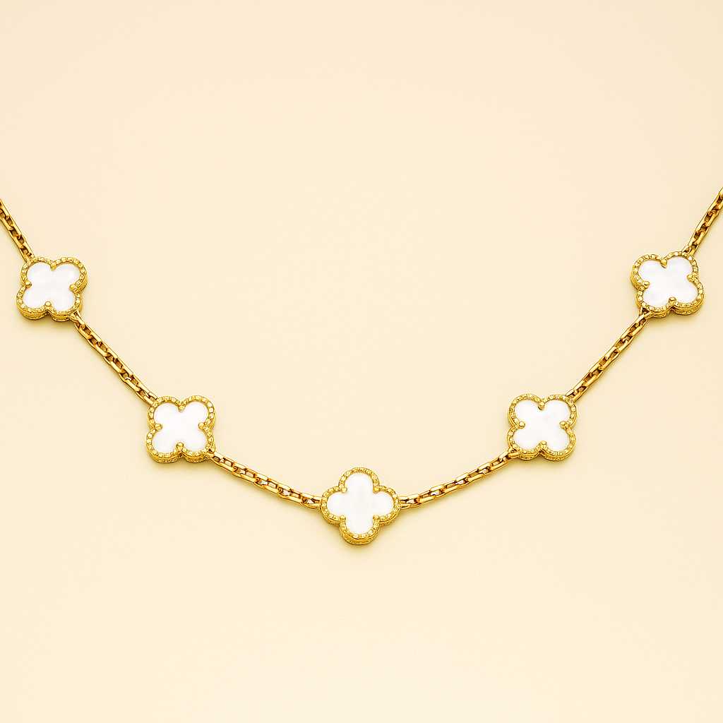 Gold necklace with clover-shaped pendants on a beige background
