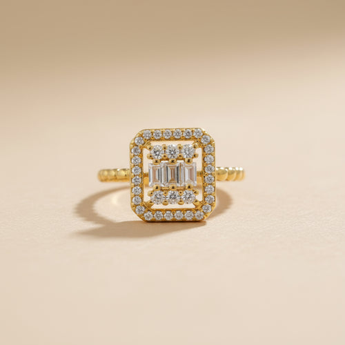 Gold ring with diamond accents on a beige background
