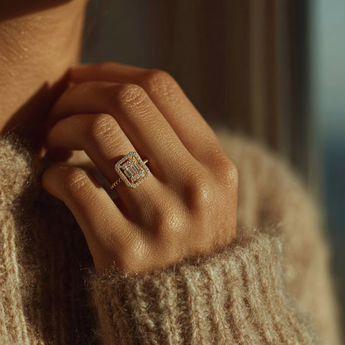 Close-up of a hand wearing a diamond ring with a blurred background