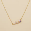 Gold necklace with soft rose gemstones on a beige background