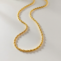 Gold rope chain on a light gray background